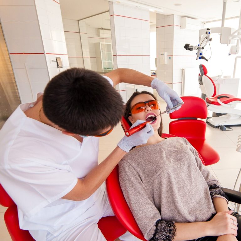 Dentist puts the seal of a beautiful girl.